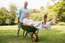 depositphotos_29453989-Cheerful-man-pushing-his-wife-in-a-wheelbarrow.jpg